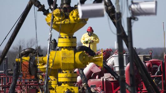 A Halliburton oil well fielder works on a well head at a fracking rig site January 27, 2016 near Stillwater, Oklahoma.