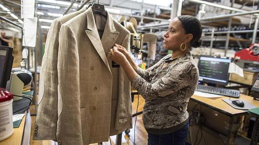 An employee attaches a tag to a jacket at the Joseph Abboud Manufacturing facility in New Bedford, Massachusetts.