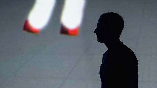 The silhouette of Mark Zuckerberg, chief executive officer and founder of Facebook Inc., is seen during the Oculus Connect 4 product launch event in San Jose, California, on Wednesday, Oct. 11, 2017.
