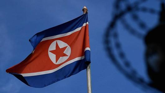 The North Korean flag is seen at mast past the barbed wire fencing of the North Korean embassy in Kuala Lumpur