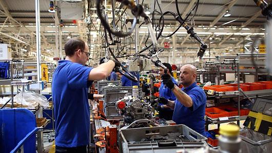 An employee works on an engine production line at a Ford factory on January 13, 2015 in Dagenham, England.