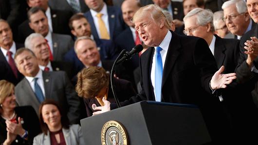 President Donald Trump celebrates with Congressional Republicans after the U.S. Congress passed sweeping tax overhaul legislation, on the South Lawn of the White House in Washington, December 20, 2017.