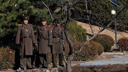 North Korean soldiers look at South next to a spot where a North Korean defected crossing the border as South Korean Defense Minister Song Young-moo visits on Nov. 27, 2017 in Panmunjom, South Korea.