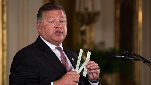 Rep. Bill Shuster (R-PA), Chairman, House T&amp;I Committee, holds up strips of paper air traffic controllers currently use, as he speaks at President Donald Trump's event announcing the Air Traffic Control Reform Initiative in the East Room of the White House, on Monday, June 5, 2017.