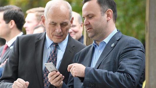 White House Director of Social Media and Assistant to the President Dan Scavino Jr. shows a message on his iPhone to White House Chief of Staff John Kelly as U.S. President Donald Trump tours the U.S. Secret Service James J. Rowley Training Center on October 13, 2017 in Beltsville, Maryland.