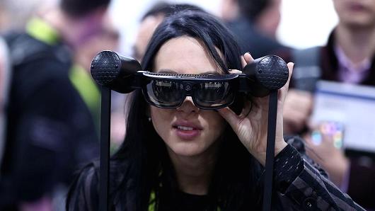 LAS VEGAS, USA - JANUARY 08 : A woman tries virtual reality and wearable technology product during the 2017 Consumer Electronics Show in Las Vegas, Nevada, USA on January 08, 2017. (Photo by Bilgin S. Sasmaz/Anadolu Agency/Getty Images)