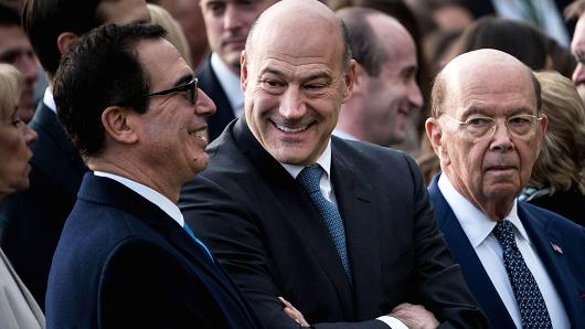 Secretary of the Treasury Steven Mnuchin (L), National Economic Council Director Gary Cohn (C) and US Secretary of Commerce Wilbur Ross wait for President Donald Trump to speak about newly passed tax reform legislation during an event at the White House December 20, 2017 in Washington, DC.