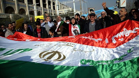 Iranians hold an Iranian flag during a protest after performing the Friday Prayer at Imam Khomeini Mosque following US' statement about backing the anti-government protests in Tehran, Iran on January 05, 2018.