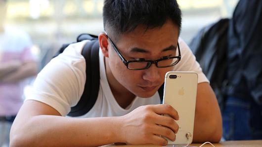 A man looks at iPhone 7 series product at an Apple store on September 16, 2016 in Beijing, China.