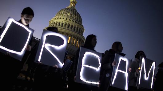 Demonstrators hold illuminated signs during a rally supporting the Deferred Action for Childhood Arrivals program (DACA), or the Dream Act, outside the U.S. Capitol building in Washington, D.C., on Thursday, Jan. 18, 2018.