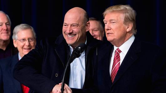 President Donald Trump shakes hands with Gary Cohn, Director of the National Economic Council, during a retreat with Republican lawmakers and members of his Cabinet at Camp David in Thurmont, Maryland, January 6, 2018.