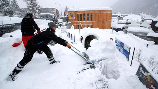 Staff removes snow ahead of the World Economic Forum (WEF) annual meeting in the Swiss Alps resort of Davos, Switzerland January 21, 2018.