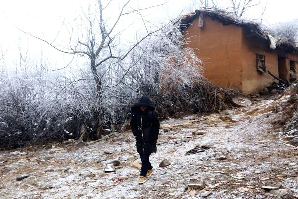 Wang Fuman, also known as 'Frost Boy', walks on the road in Ludian in China's southwestern Yunnan province on January 12, 2018.