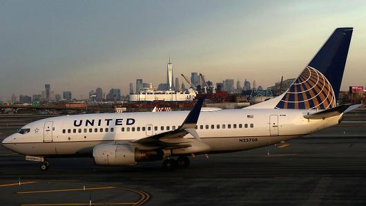A United Airlines airplane passes the skyline of lower Manhattan and One World Trade Center as it heads to a runway at Newark Liberty Airport on January 20, 2018 in Newark, New Jersey.