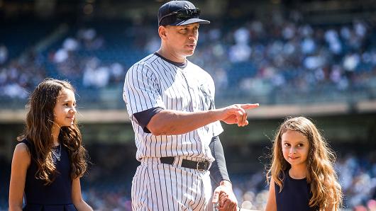 Alex Rodriguez #13 of the New York Yankees enters the field with daughters Natasha and Ella during the pre-game ceremony honoring Alex's 3000th hit before the game against the Toronto Blue Jays at Yankee Stadium on September 13, 2015 in the Bronx borough of New York City.