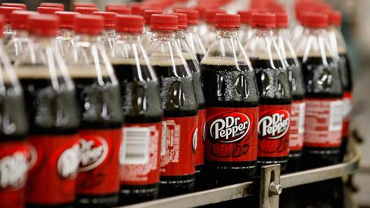Bottles of Dr. Pepper soft drinks move down a production line in West Valley City, Utah.