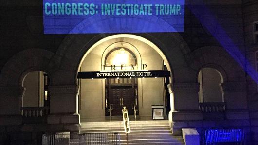 A group is projecting messages outside the Trump International Hotel in Washington D.C. ahead of the State of the Union tonight.