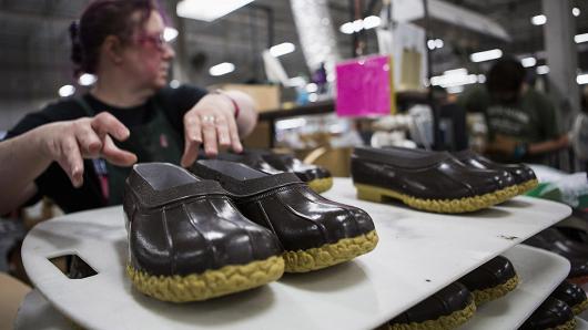 A worker stacks the bottoms of boots during production at the L.L. Bean manufacturing facility in Brunswick, Maine.