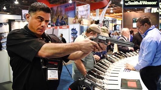 A man checks out a model S&W500 handgun at the Smith & Wesson booth during the 2016 National Shooting Sports Foundation's Shooting, Hunting, Outdoor Trade (SHOT) Show at the Sands Expo and Convention Center in Las Vegas, Nevada.