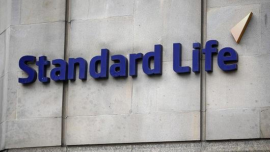 A Standard Life logo sits on a wall outside Standard Life House, the headquarters of Standard Life Plc, in Edinburgh, U.K., on Saturday, Aug. 9, 2014.
