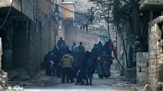 People carry belongings as they flee deeper into the remaining rebel-held areas of Aleppo, Syria December 12, 2016.
