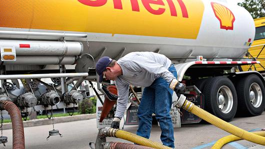 A driver delivers 7,500 gallons of unleaded gasoline to a Shell station in Peoria, Illinois.