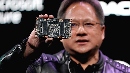 Jensen Huang, CEO of Nvidia, shows the NVIDIA Volta GPU computing platform at his keynote address at CES in Las Vegas, January 7, 2018.