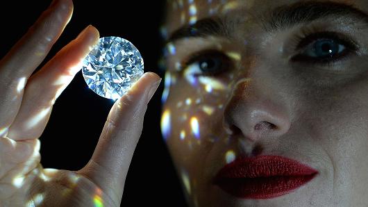 A model holds a 102.34 carat white diamond, described as the rarest white diamond ever to come to market, at Sotheby's in New Bond Street, London, ahead of its private sale at Sotheby's Diamonds retail boutique and is expected to fetch in excess of 33.7 million US dollars.