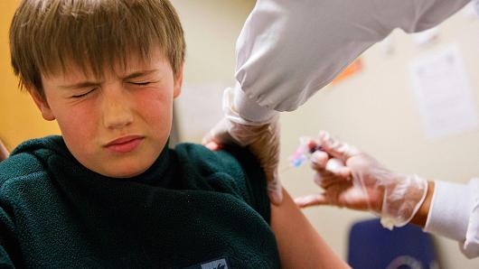 Reed Olson, 8, gets a flu shot at a Dekalb County health center in Decatur, Ga., Monday, Feb. 5, 2018.