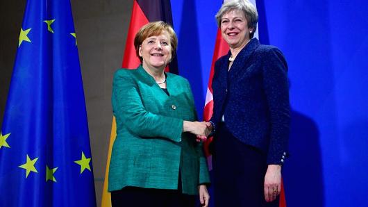 German Chancellor Angela Merkel and British Prime Minister Theresa May shake hands during a joint press conference after talks on February 16, 2018 in Berlin.
