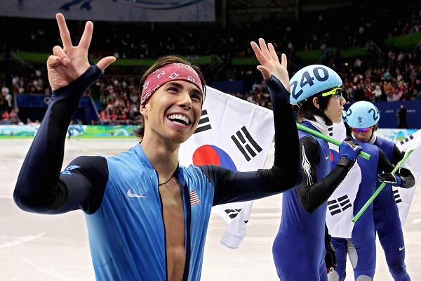 Apolo Anton Ohno of the U.S. holds up eight fingers to signify his tally of Olympic medals after the Men's 5000m Relay Short Track Speed Skating Final at the 2010 Vancouver Winter Olympics.