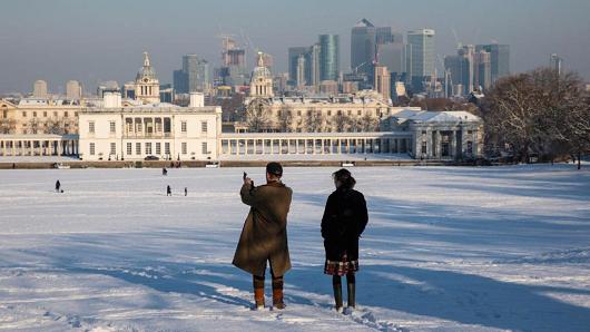 People stop and take a picture in a snow-covered Greenwich Park on February 28, 2018 in London, United Kingdom