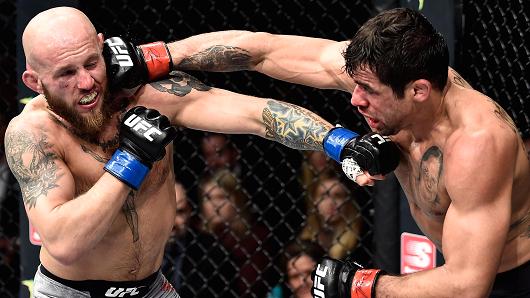 Renan Barao of Brazil punches Brian Kelleher in their bantamweight bout during the UFC Fight Night event at Amway Center on February 24, 2018 in Orlando, Florida.