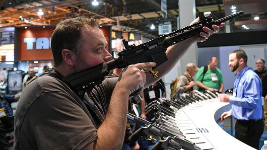 An attendee tries out an M&P 15-22 Sport rifle at the Smith & Wesson booth at the 2016 National Shooting Sports Foundation's Shooting, Hunting, Outdoor Trade (SHOT) Show at the Sands Expo and Convention Center on January 19, 2016 in Las Vegas, Nevada.