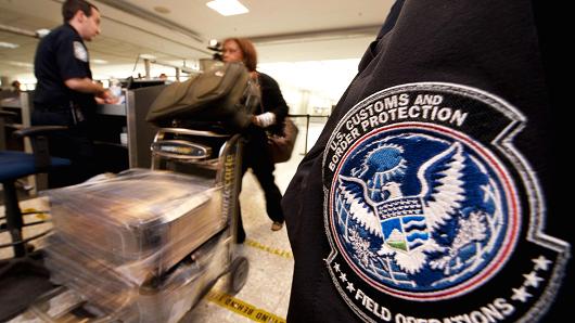 An international air traveler is cleared by a U.S. Customs and Border Protection Officer inside the U.S. Customs and Immigration area at Dulles International Airport.