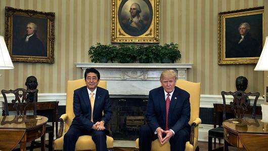 Japan's Prime Minister Shinzo Abe and US President Donald Trump wait for a meeting in the Oval Office of the White House on February 10, 2017 in Washington, DC.