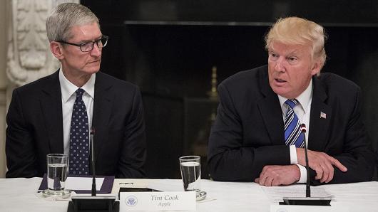President Donald Trump, right, speaks as Tim Cook, chief executive officer of Apple Inc., listens during the American Technology Council roundtable hosted at the White House in Washington, D.C.