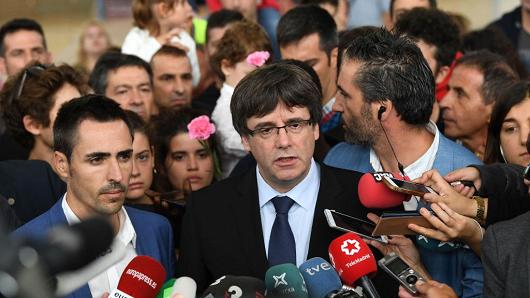 : Catalonia President Carles Puigdemont speaks to the medai after failing to vote in the referendum because of the Spanish police closing his polling station on October 1, 2017 in Sant Julia de Ramis, Spain. More than five million eligible Catalan voters are estimated to visit 2,315 polling stations today for Catalonia's referendum on independence from Spain. The Spanish government in Madrid has declared the vote illegal and undemocratic.