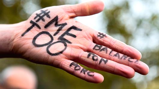 A picture shows the messages '#Me too' and #Balancetonporc ('expose your pig') on the hand of a protester during a gathering against gender-based and sexual violence called by the Effronte-e-s Collective, on the Place de la Republique square in Paris on October 29, 2017.