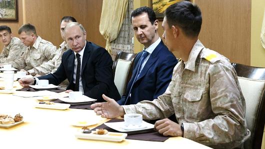 Russian President Vladimir Putin (3 R) meets with President of Syria, Bashar al-Assad (2 R) during his visit at the Hmeymim base in Syria's Latakia on December 11, 2017.