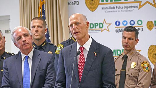 Florida Gov. Rick Scott talks alongside Miami-Dade County mayor Carlos A. Gimenez, left, during a news conference at Miami-Dade Police Department in Doral, Fla., on Tuesday, Feb. 27, 2018.