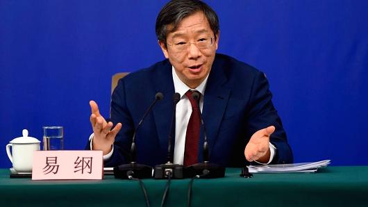 Yi Gang, Deputy Governor of People's Bank of China (PBC), answers a question at a press conference during the First Session of the 13th National People's Congress in Beijing.