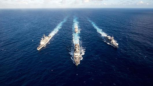 The guided missile destroyer USS Mustin leads the guided missile cruiser USS Antietam, the guided missile destroyer USS Curtis Wilbur and the Japan Maritime Self-Defense Force destroyer JS Fuyuzuki in a formation at the completion of the MultiSail 2018 exercise in the Philippine Sea, March 14, 2018.