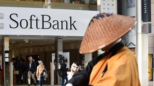 The logo of Japanese mobile provider SoftBank is displayed at an entrance of a shop in Tokyo's shopping district Ginza on February 8, 2017.