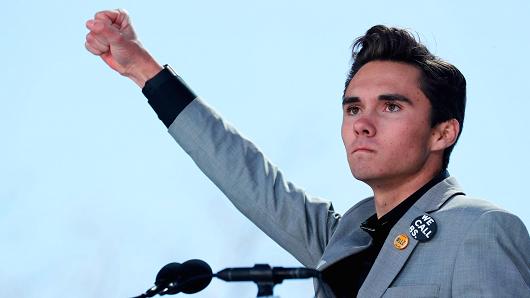 David Hogg, a student at the Marjory Stoneman Douglas High School, site of a February mass shooting which left 17 people dead in Parkland, Florida, thrusts his fist in the air as he speaks during the "March for Our Lives" event demanding gun control after recent school shootings at a rally in Washington, March 24, 2018.