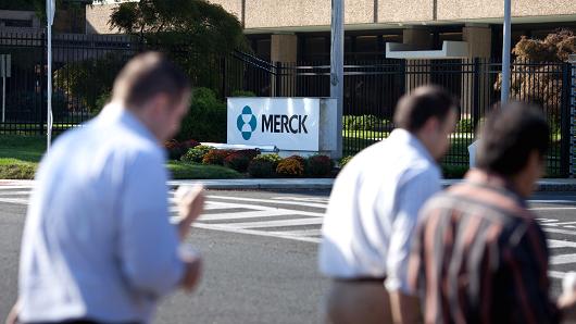 Pedestrians walk across the street from a Merck & Co. facility in Summit, New Jersey