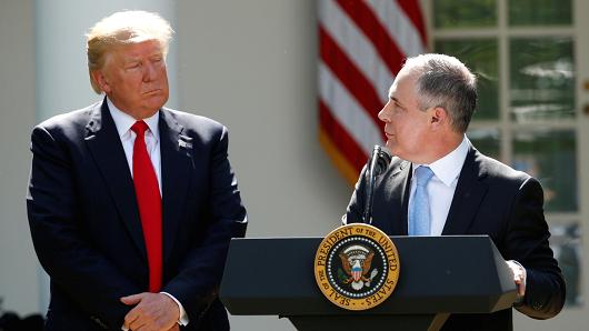 President Donald Trump (L) listens to EPA Administrator Scott Pruitt after announcing his decision that the United States will withdraw from the Paris Climate Agreement, in the Rose Garden of the White House in Washington, U.S., June 1, 2017.