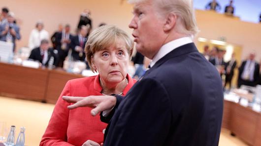 U.S. President Donald Trump talks to German Chancellor Angela Merkel before the first working session of the G20 meeting in Hamburg, Germany, July 7, 2017.