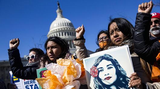 Demonstrators raise their fists in protest of President Trump's attempts to end the Deferred Action for Childhood Arrivals (DACA), an executive action made by President Obama that protected minors known as Dreamers who entered the country illegally from deportation, outside of the U.S. Capitol in Washington, March 5, 2018.