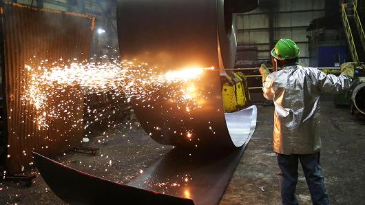 A worker cuts a steel coil at the Novolipetsk Steel PAO steel mill in Farrell, Pennsylvania, March 9, 2018.